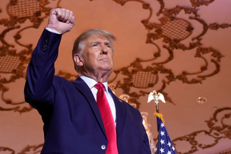 Former President Donald Trump stands on stage after announcing a third run for president as he speaks at Mar-a-Lago in Palm Beach