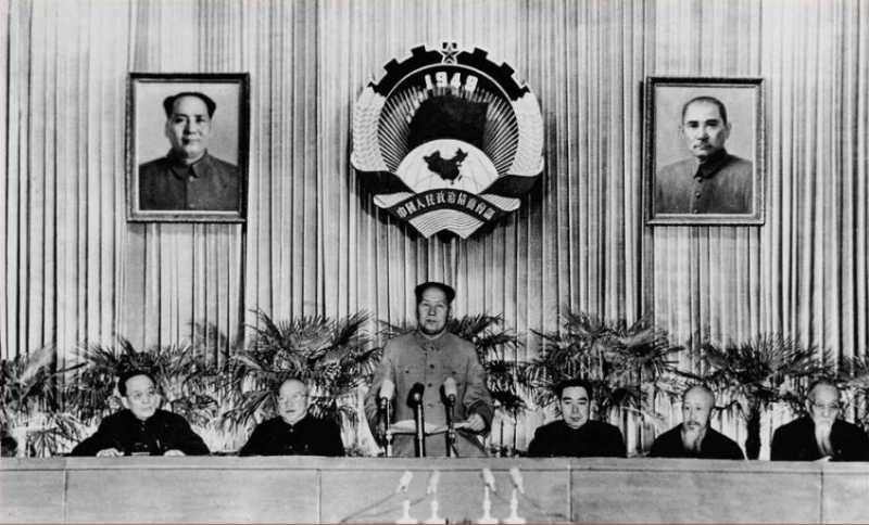 50年代的政协会议，主席台上有政协会徽，还有毛泽东和孙中山的画像。
