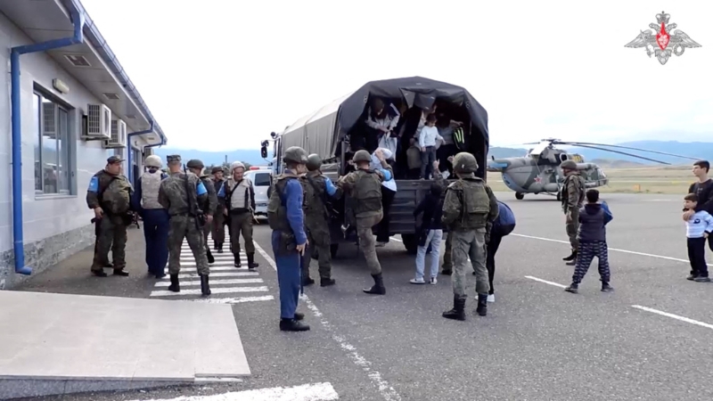 2023年9月20日，阿塞拜疆军队在卡拉巴赫地区发起军事行动后，俄罗斯维和人员在进行疏散，平民从卡车上走出来。