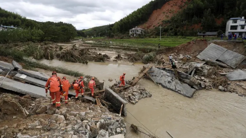 2024年7月29日，湖南郴州，资兴市八面山瑶族乡，消防救援队员通过简易木桥徒步前往灾区。